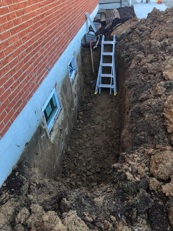 digging out an area for egress window wells springfield il